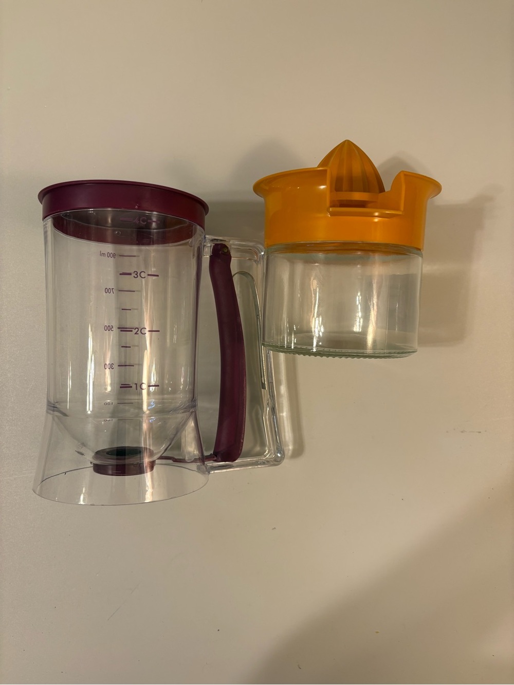 Clear pancake batter dispenser with squeezeHandle and Orange Citrus Juicer